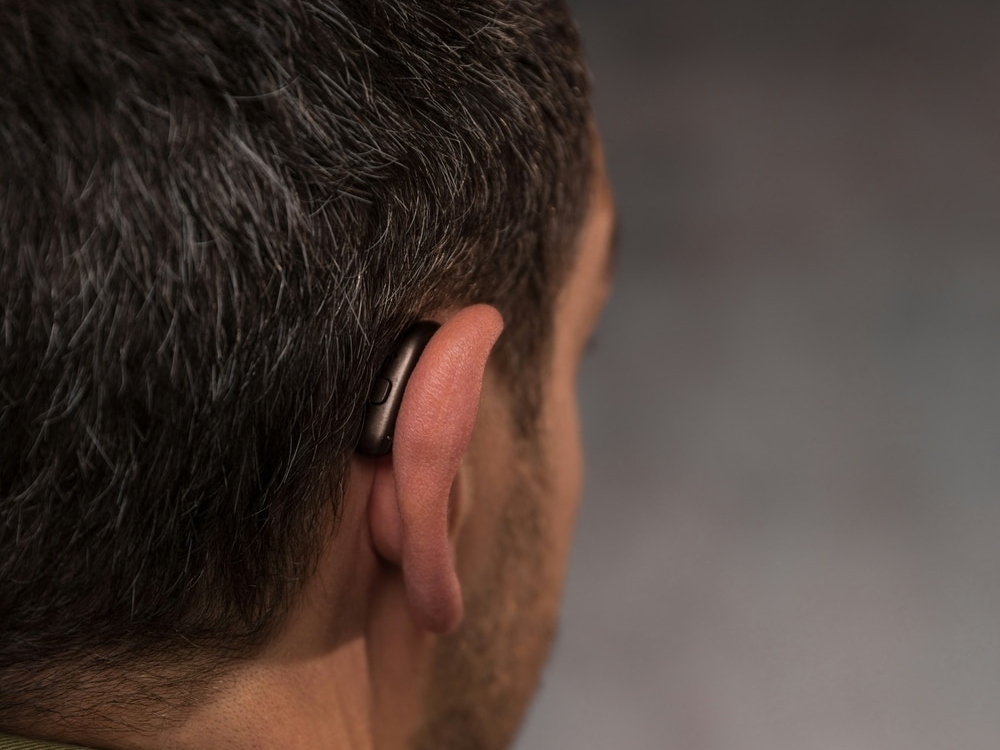 Close-up of a behind-the-ear hearing aid worn after a fitting at The Hearing Place in Falconer, NY