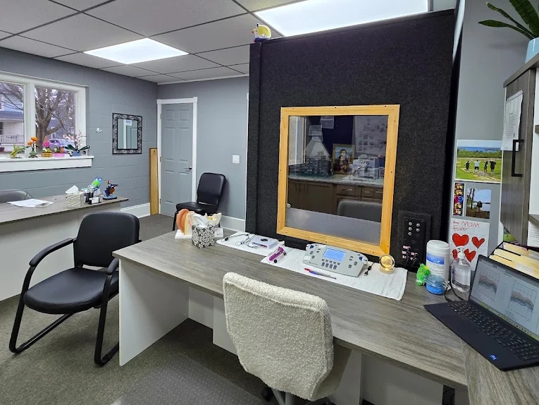 Testing room with audiometer and sound booth used for hearing evaluations at The Hearing Place in Falconer, NY