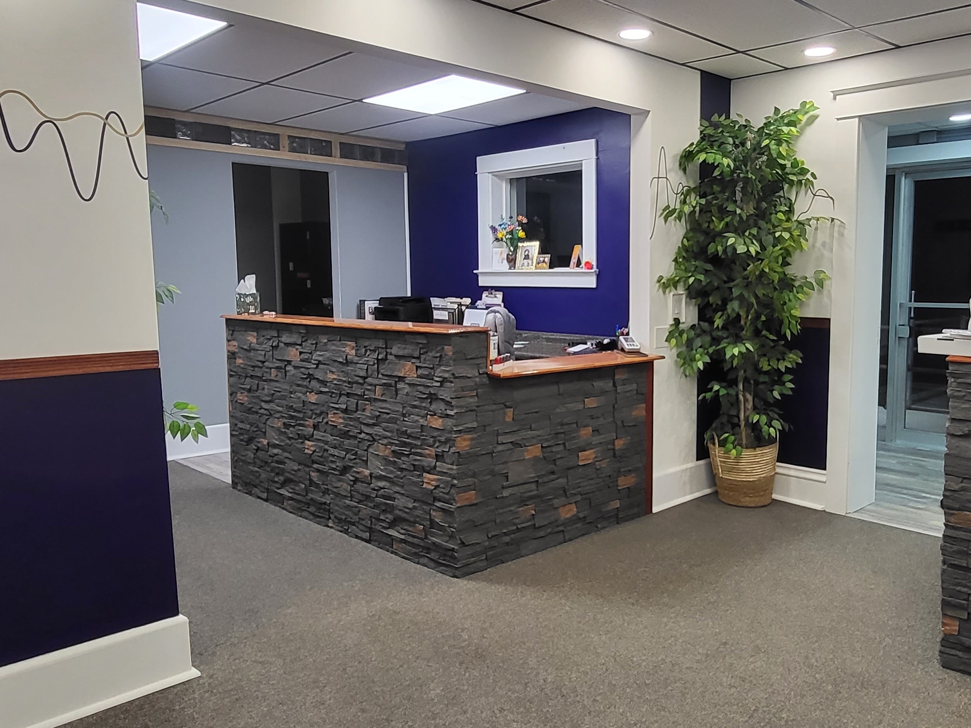 Stone reception desk in the renovated front office of The Hearing Place in Falconer, NY