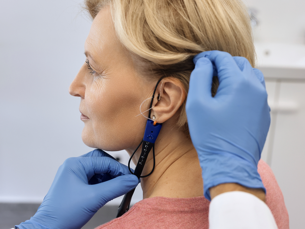 Real Ear Measurement probe microphone placed in a patient's ear to verify a hearing aid fitting in Falconer, NY